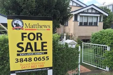 a sign in front of a house
